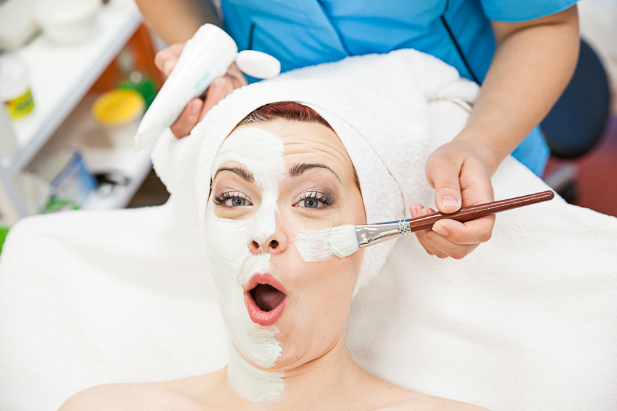 Woman's face half covered with a special caring mask, beautician service at Värska spa treatment centre.