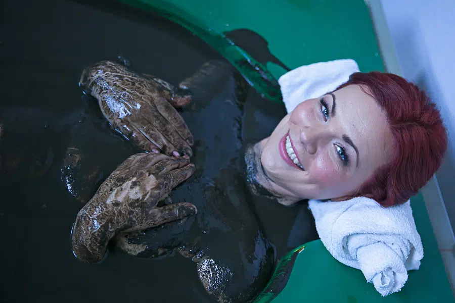 Женщина в грязевой ванне в лечебном центре курорта Вярска.